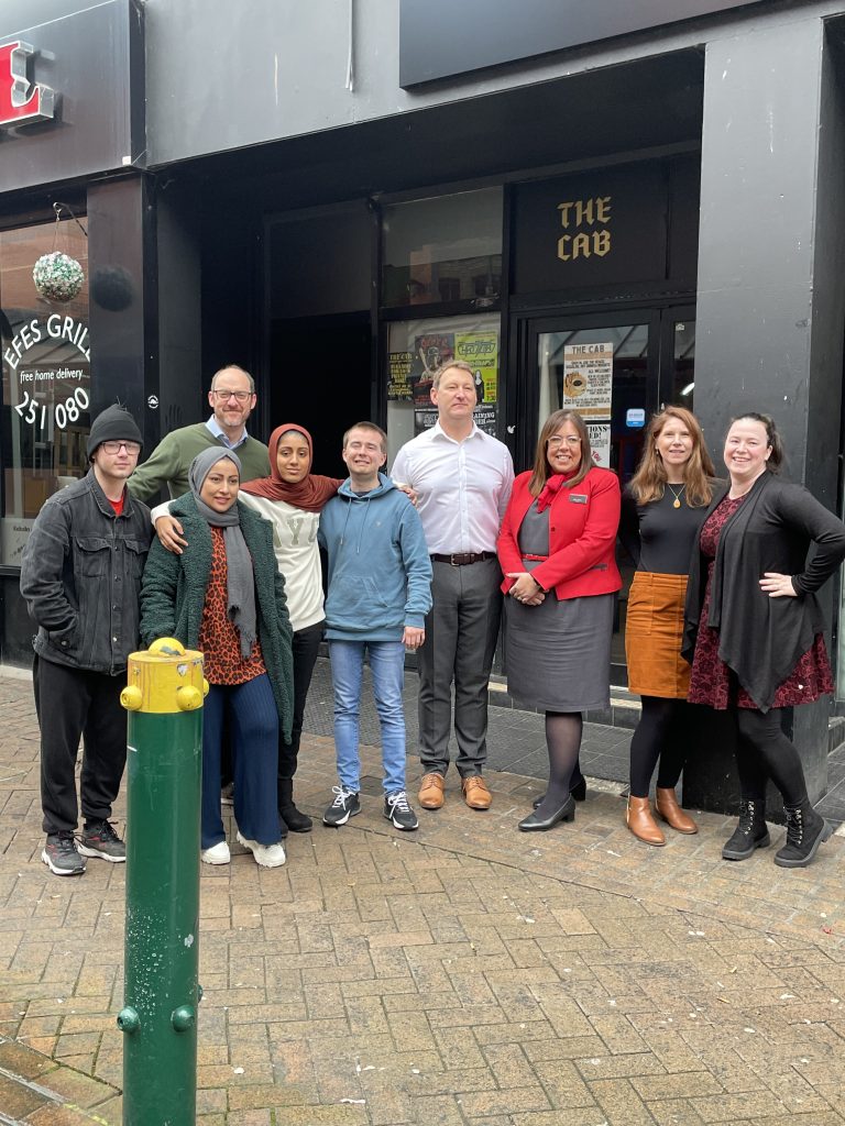 A group photo outside Reality Theatre.
